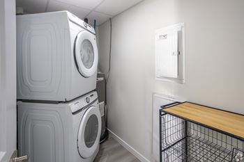 A laundry room with a washer and dryer stacked on top of each other.